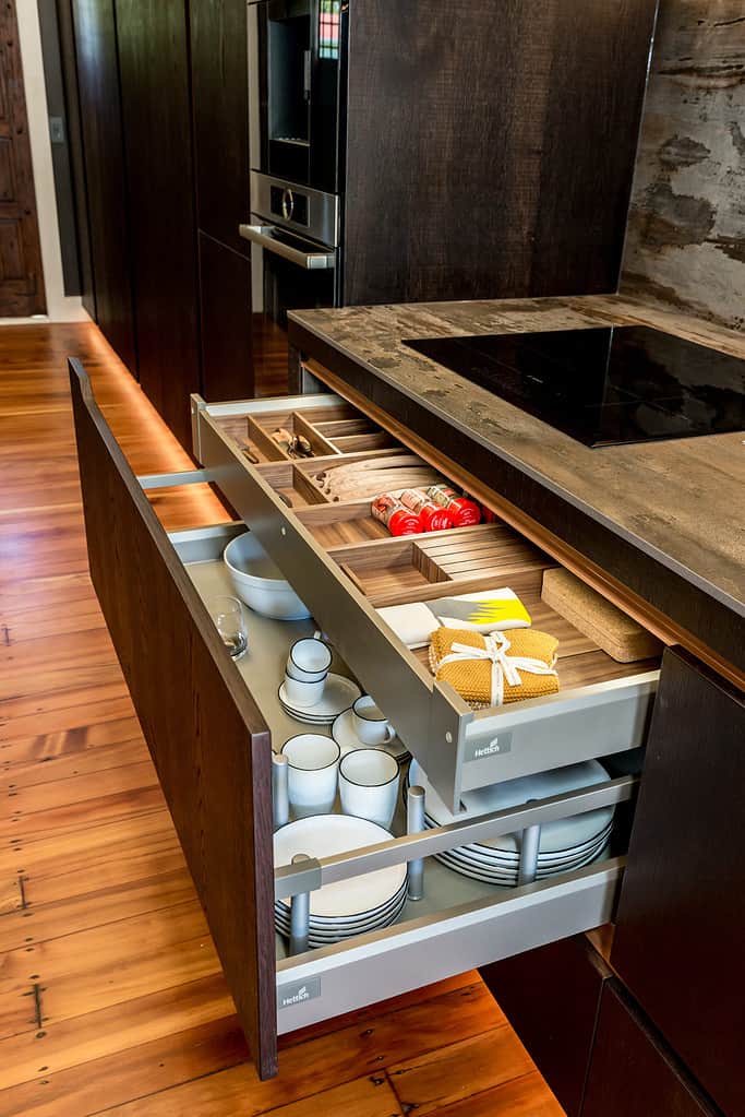 Designed by Yellowfox, this kitchen has multi-use pull-out drawers underneath the stovetop