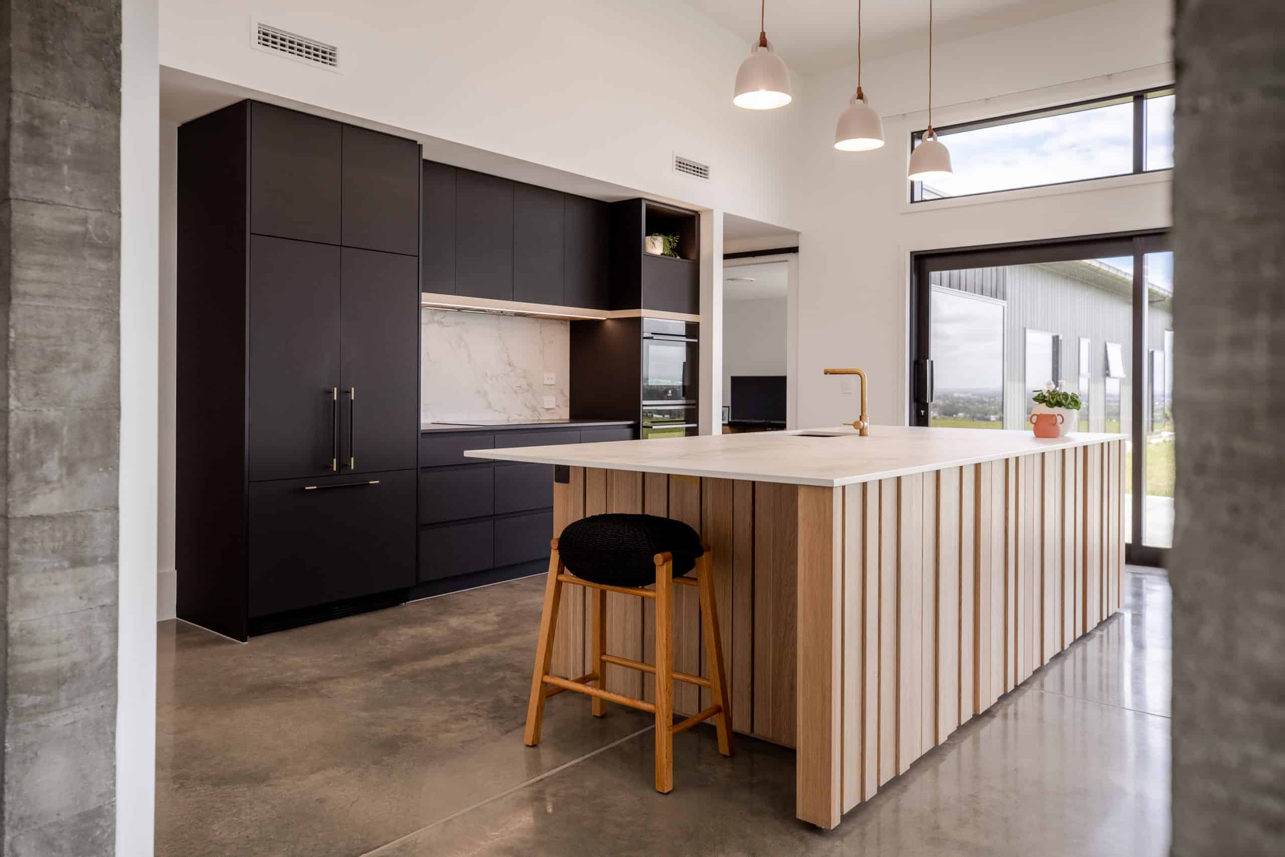 Matte black kitchen using Avantech You with vertical wooden panelling on kitchen island