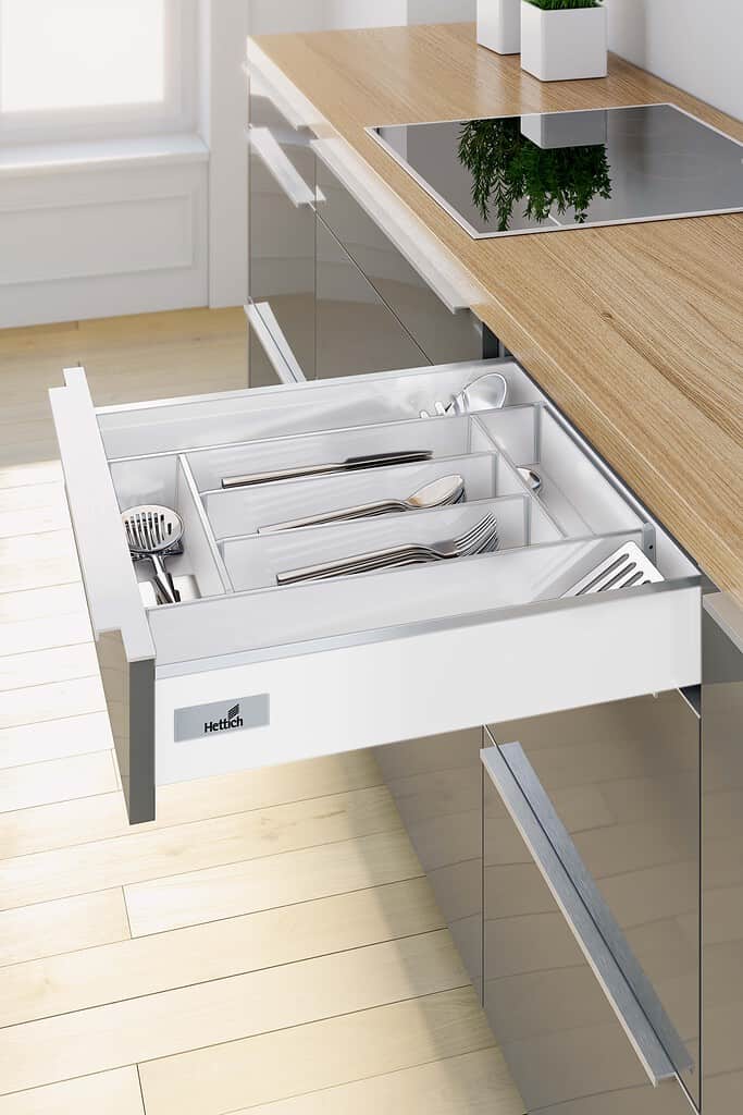 White drawer with cutlery inserts and silver panel front