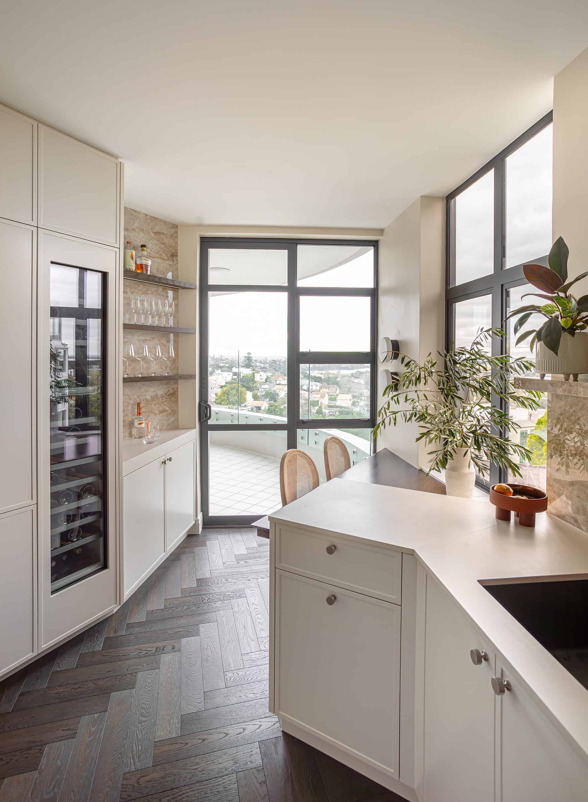 Cream kitchen with city views and a wine fridge