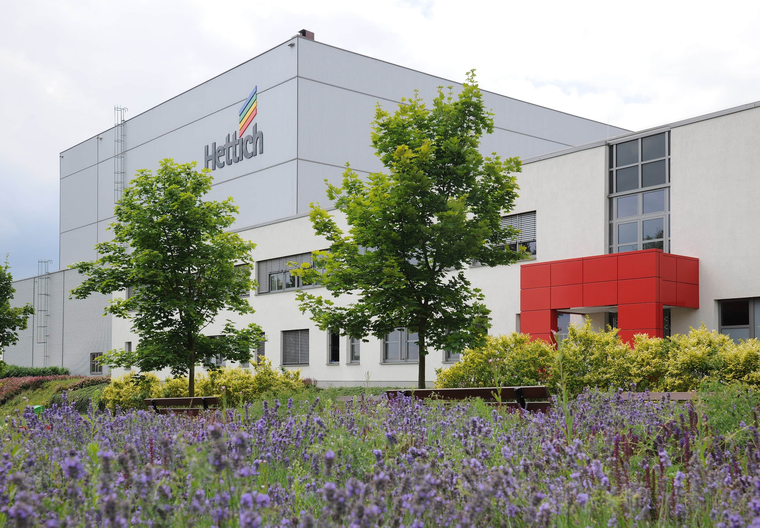 Hettich's production facility main entrance surrounded by lavender, tress and greenery